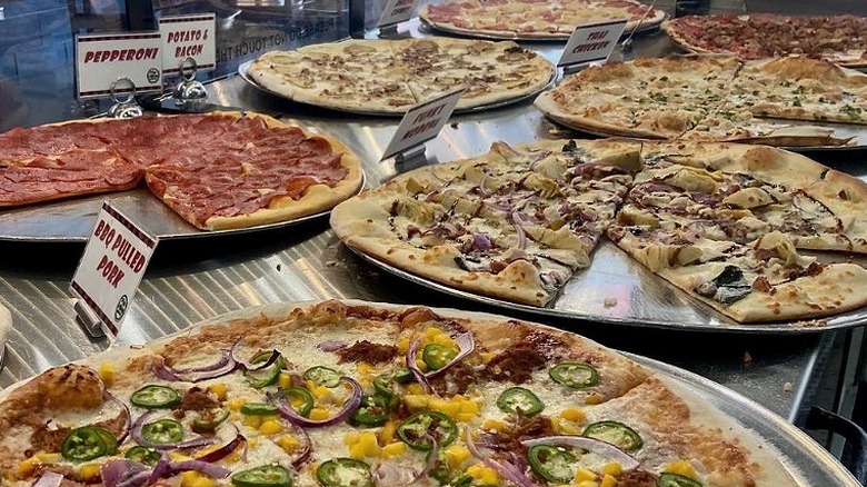 various pizzas in a display case