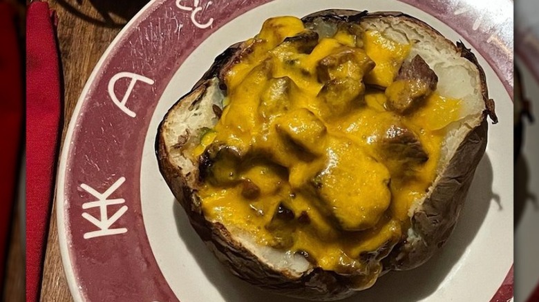 baked potato with steak and cheese