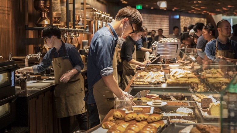 Baristas working at a Starbucks Reserve pastry counter