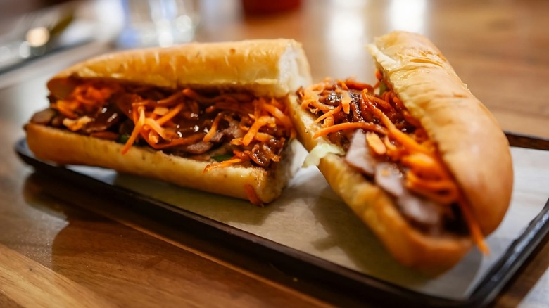 Shredded carrot kimchi on long sandwich bun with pork