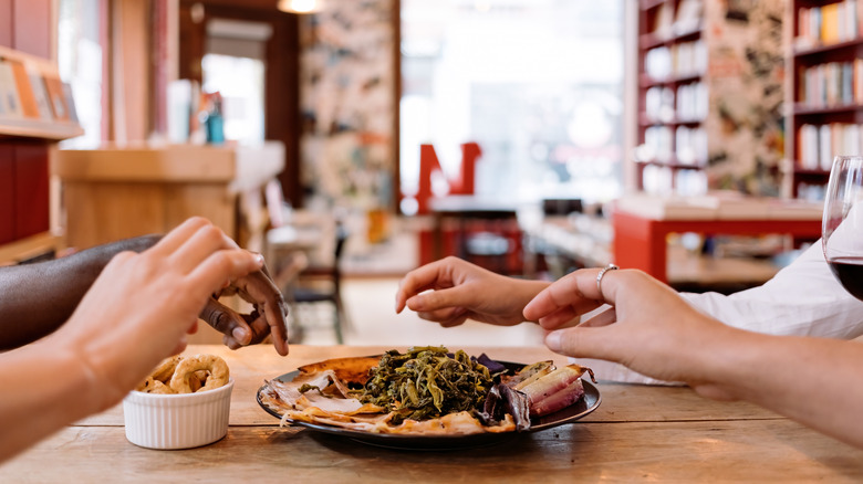 People sharing food at restaurant