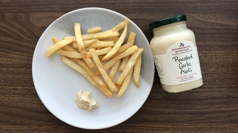 Plate of fries and jar of garlic aioli