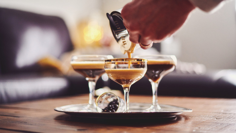 Bartender's hands pouring an espresso martini