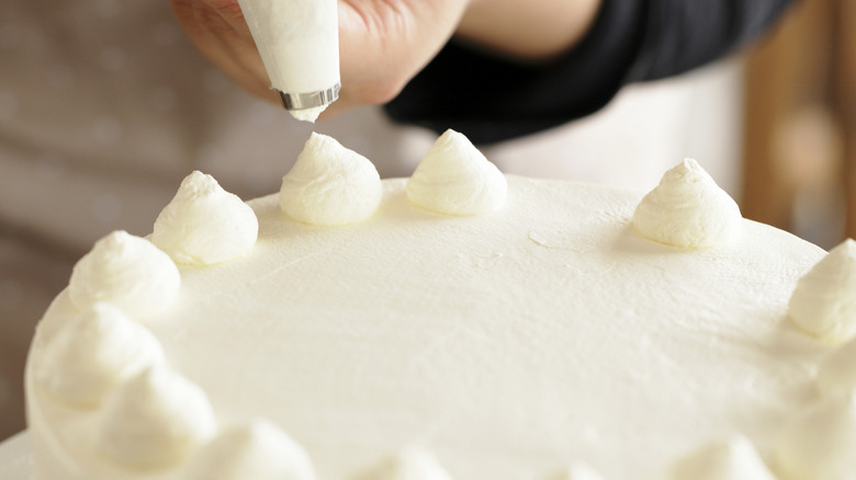 Piping icing onto cake