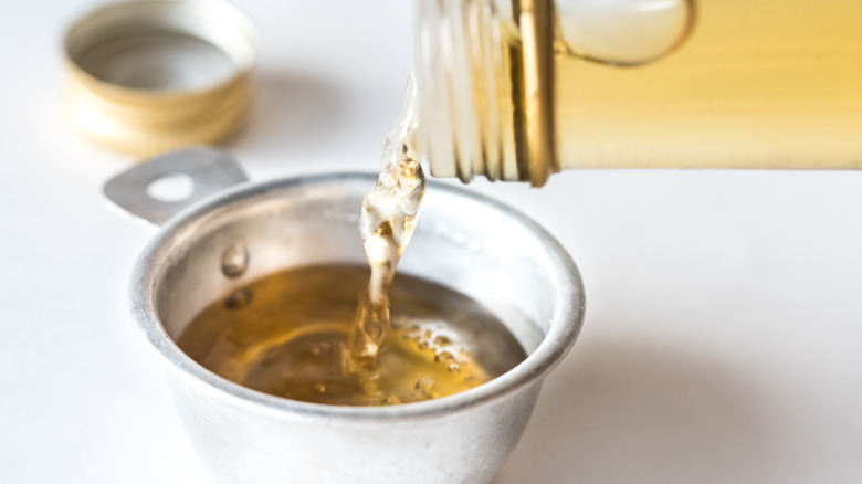 Vinegar being poured into a cup