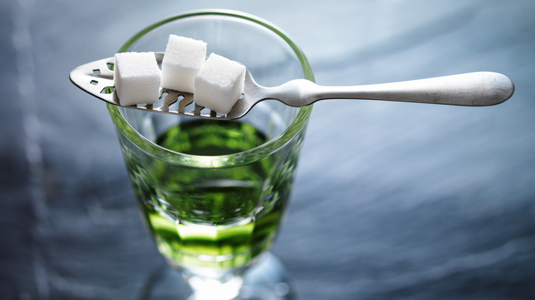 Absinthe glass with spoon and sugar cubes