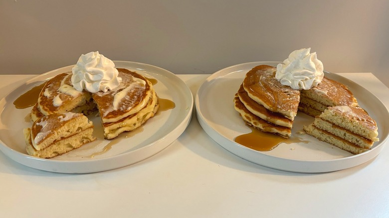 Two white plates with IHOP and Denny's pancakes sliced with whipped cream