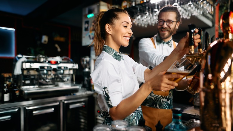 two bartenders working together