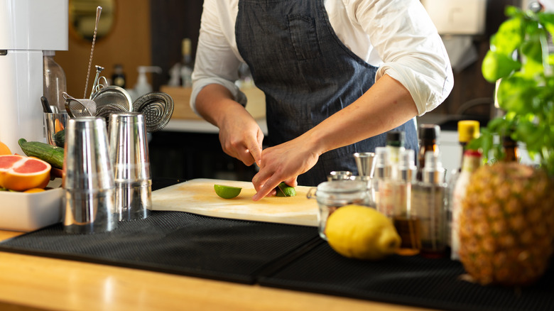 bartender cutting lime slices