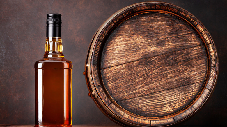 Barrel and bourbon bottle