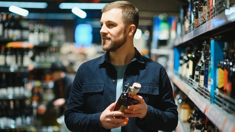 Man holding whiskey bottle