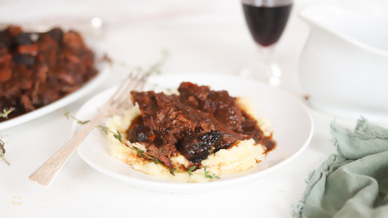 Fig pot roast over mashed potatoes on a plate