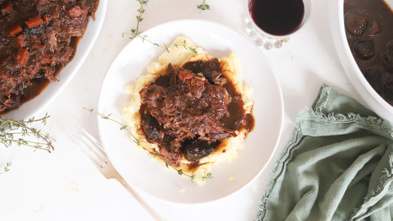 plate of pot roast over mashed potatoes