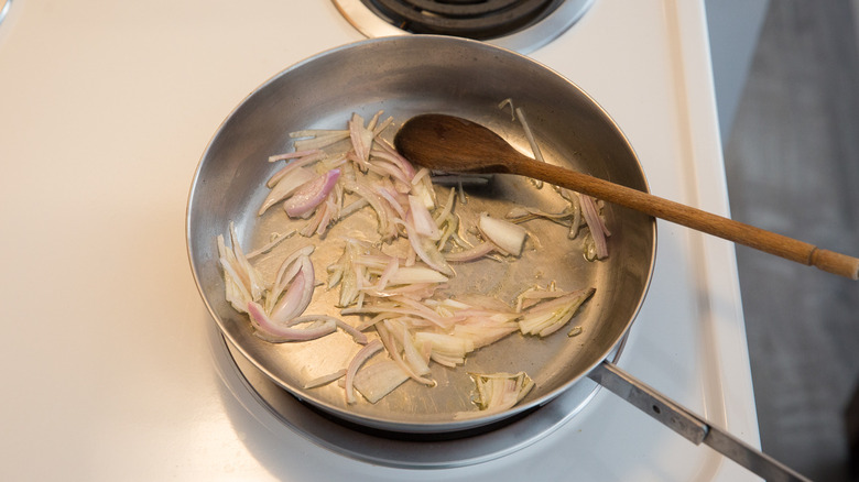 shallots sauteing in metal pan