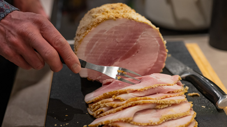 carving ham on table