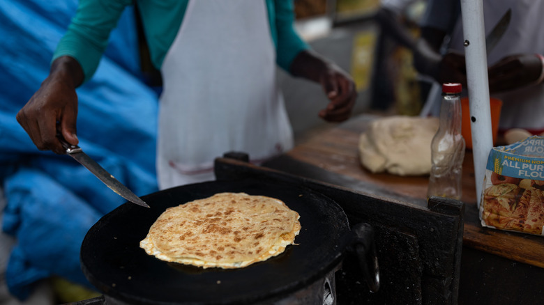 Street vendor cooking a rolex