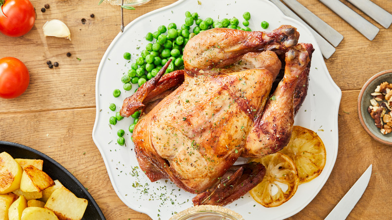 Roast chicken dinner with peas and lemon