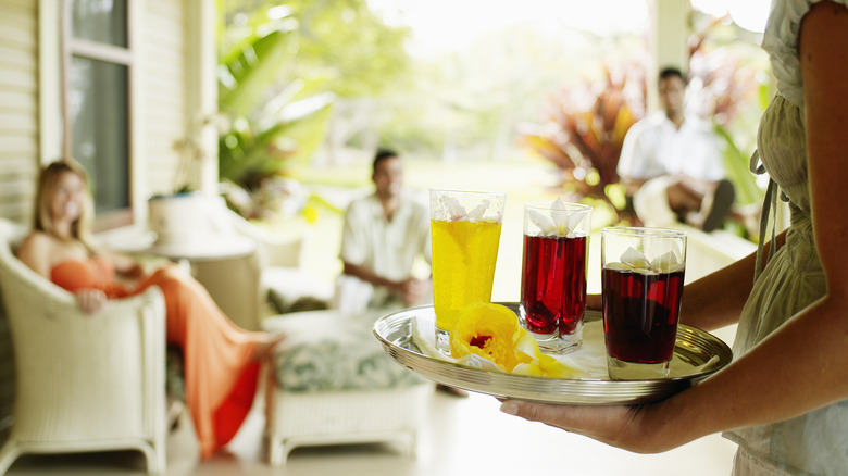 hostess carrying drinks on tray