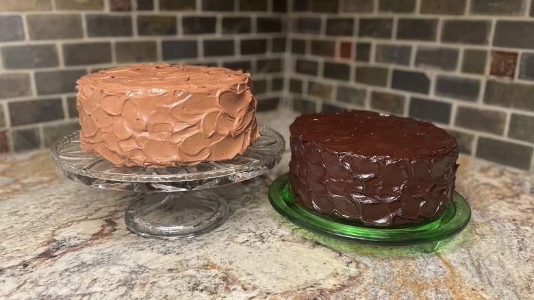 Two chocolate cakes on trays