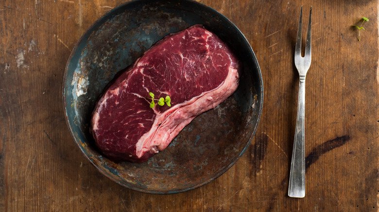 Uncooked steak on a plate