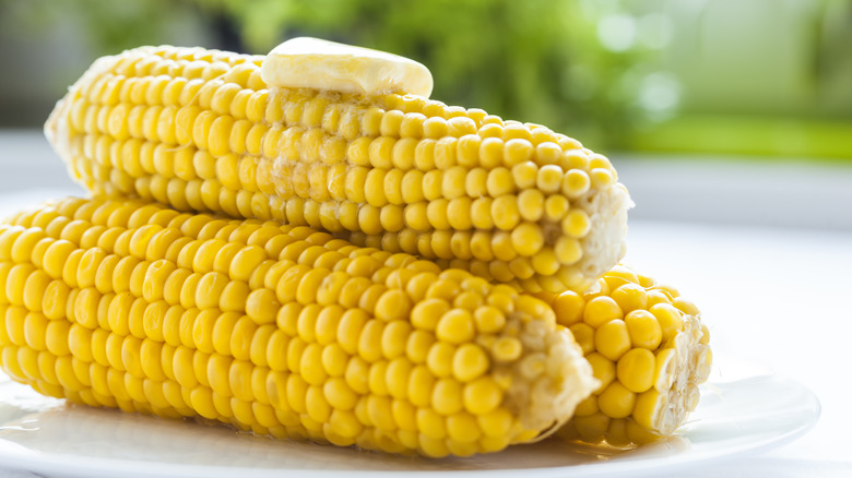 Three corn cobs with butter