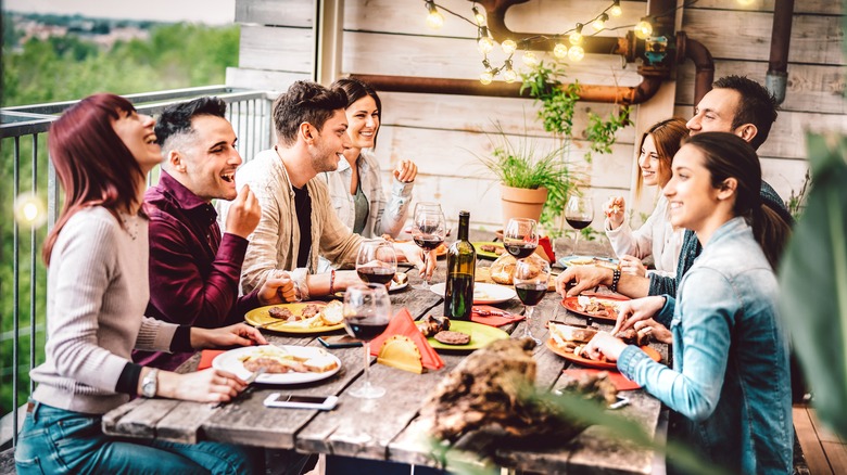 Dinner party around wood table