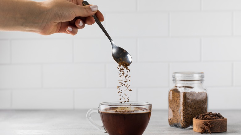 Stirring instant coffee into glass