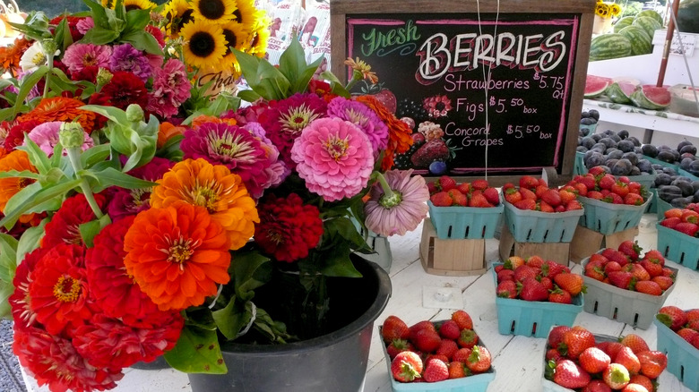 farm stand with zinnias and strawberries