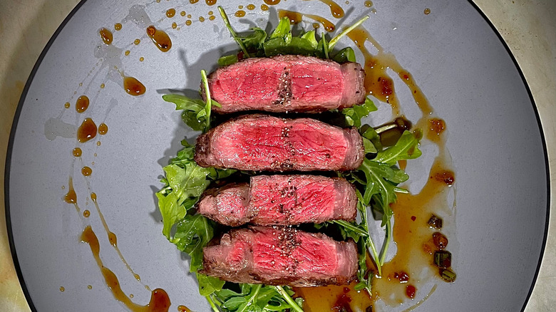 plated arugula salad and steak