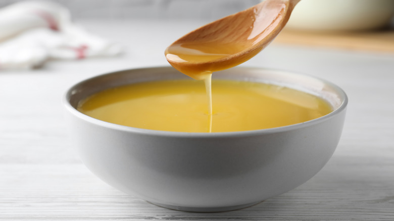 clarified butter in white bowl with spoon