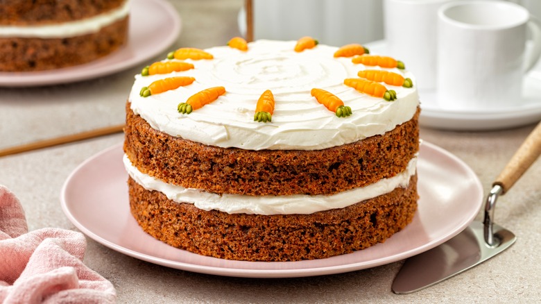 Frosted carrot cake on a pink plate