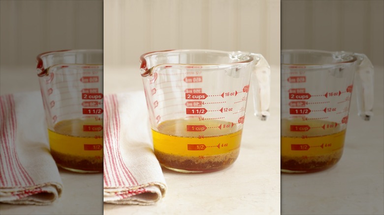 Salad dressing in measuring cup