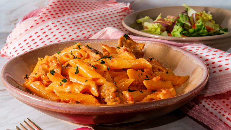 vodka sauce on pasta with salad