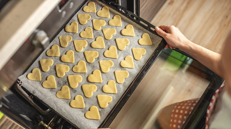 Heart-shaped cookies on baking sheet