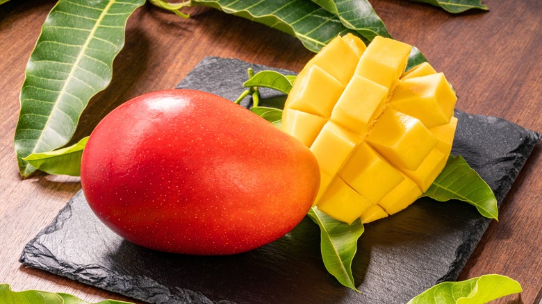 Fresh mangoes sliced and unsliced