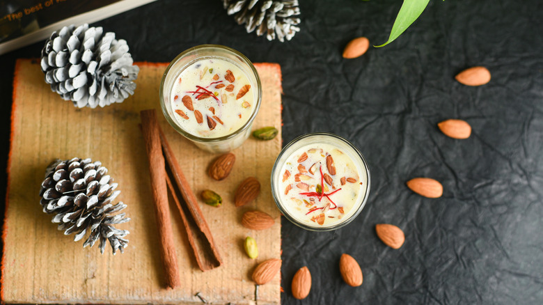 Aerial view of badam milk glasses and almonds