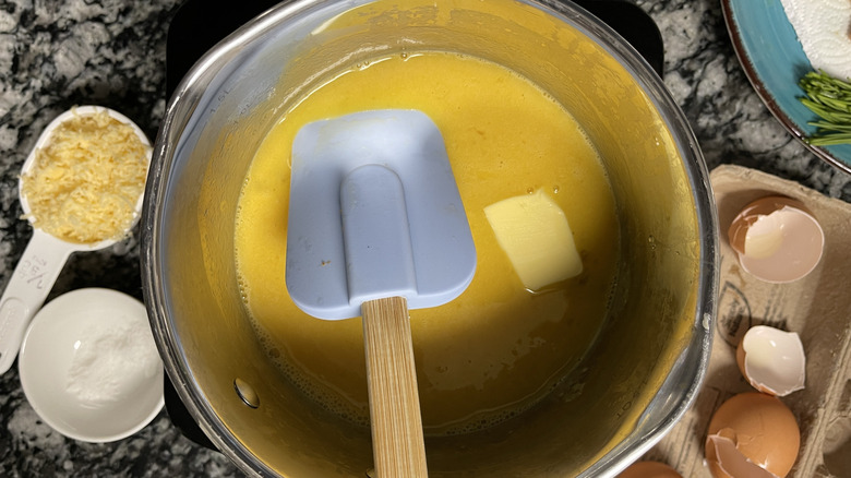 stirring beaten eggs with butter