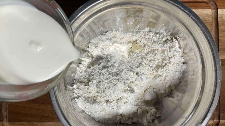 pouring cream in biscuit dough