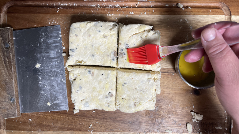 brushing biscuit dough with egg