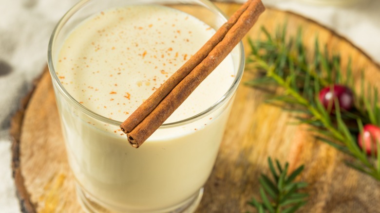 Eggnog glass with cinnamon sticks