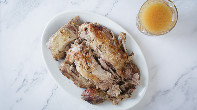 overhead view of duck on platter with sauce