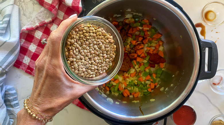 adding lentils to pot