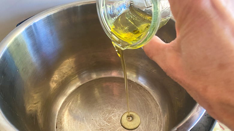 adding oil to pot