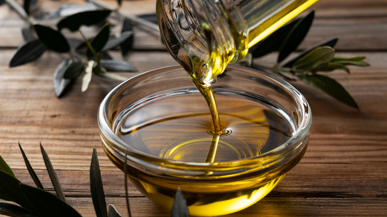 oil being poured in glass