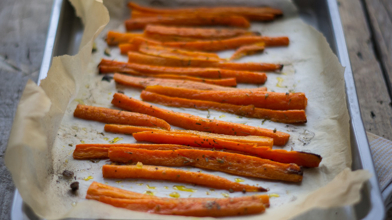 crisped roasted carrots lined over a baking sheet