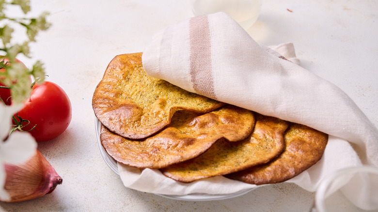 flatbreads in a towel on plate