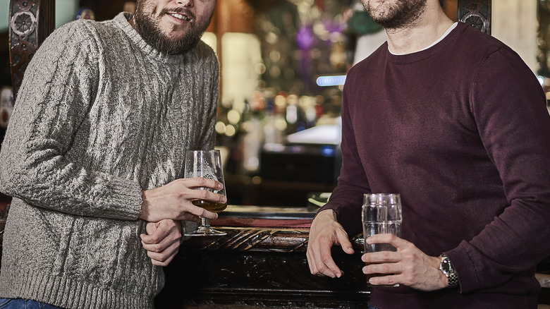 Two friends drinking together in a pub