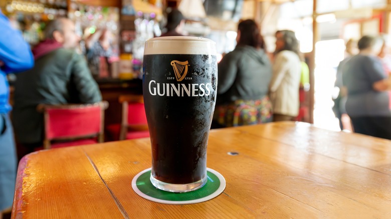 Guinness in an Irish pub with people around in the daytime