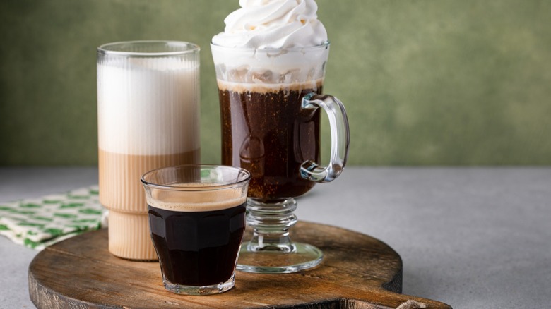 Three different Irish Coffees on a wooden board