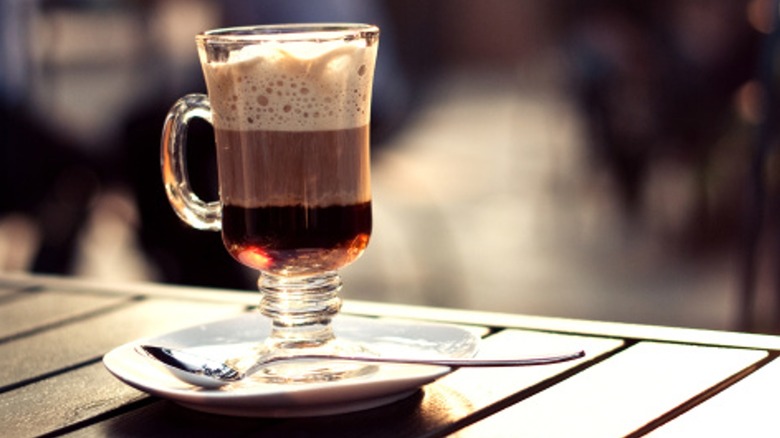 Irish Coffee on a saucer with a spoon